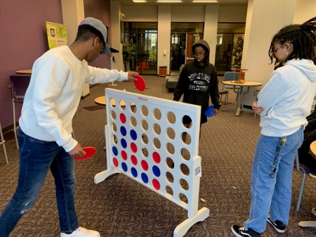 Students playing giant connect four. 